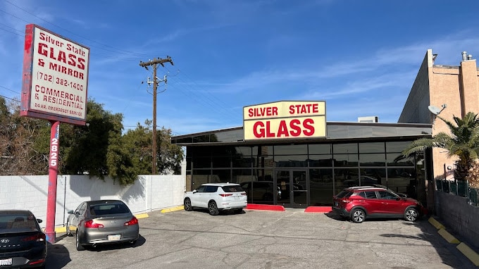 Exterior View Of The Silver State Glass & Mirror Co. &Amp; Mirror Building, Showcasing The Company'S Signage And Parking Lot On A Sunny Day.