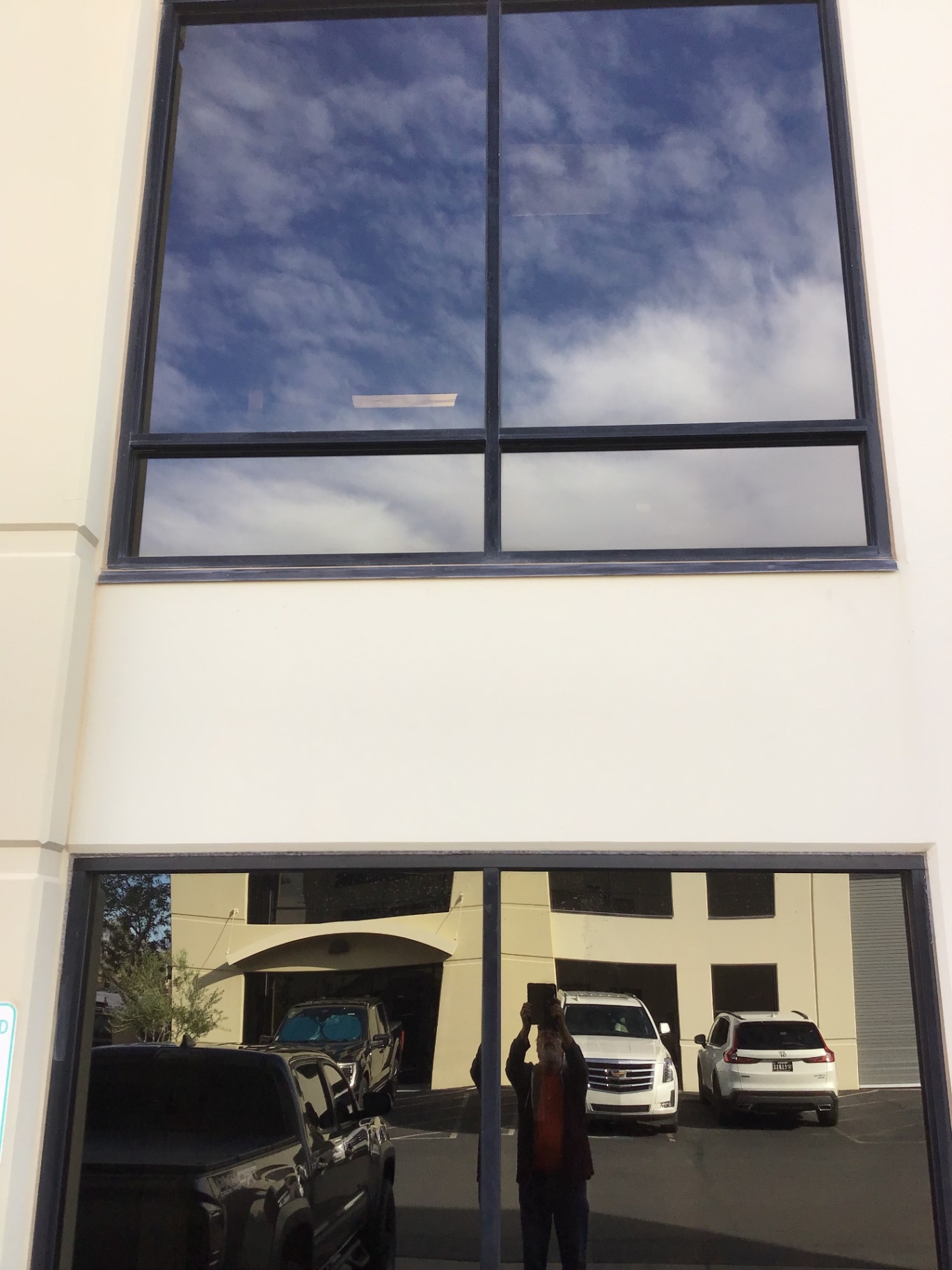 A two-story commercial storefront with tinted glass
