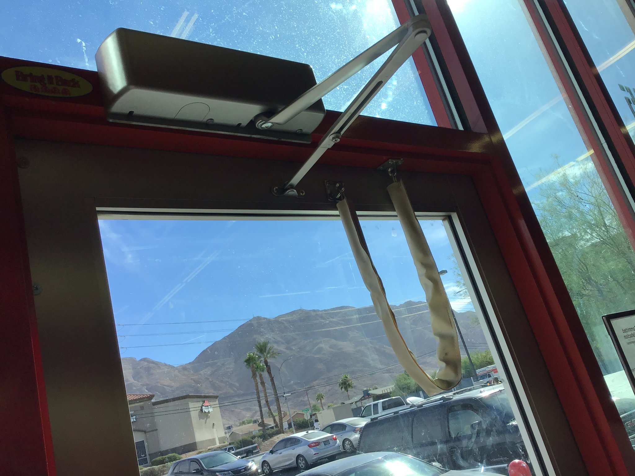 Door closer mounted on a commercial entry door in Las Vegas