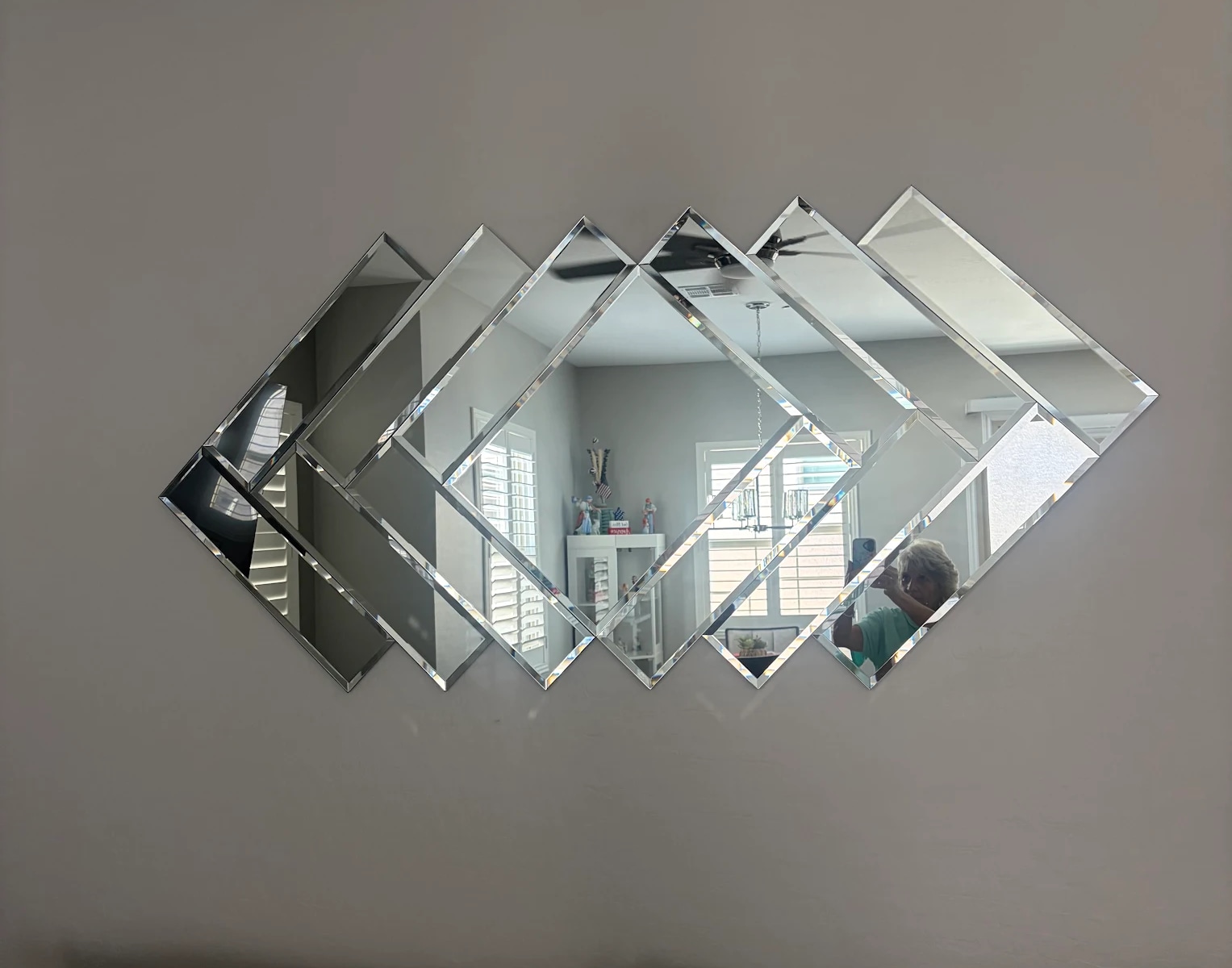 A custom bevelled mirror wall of overlapping diamond panels in a Las Vegas home