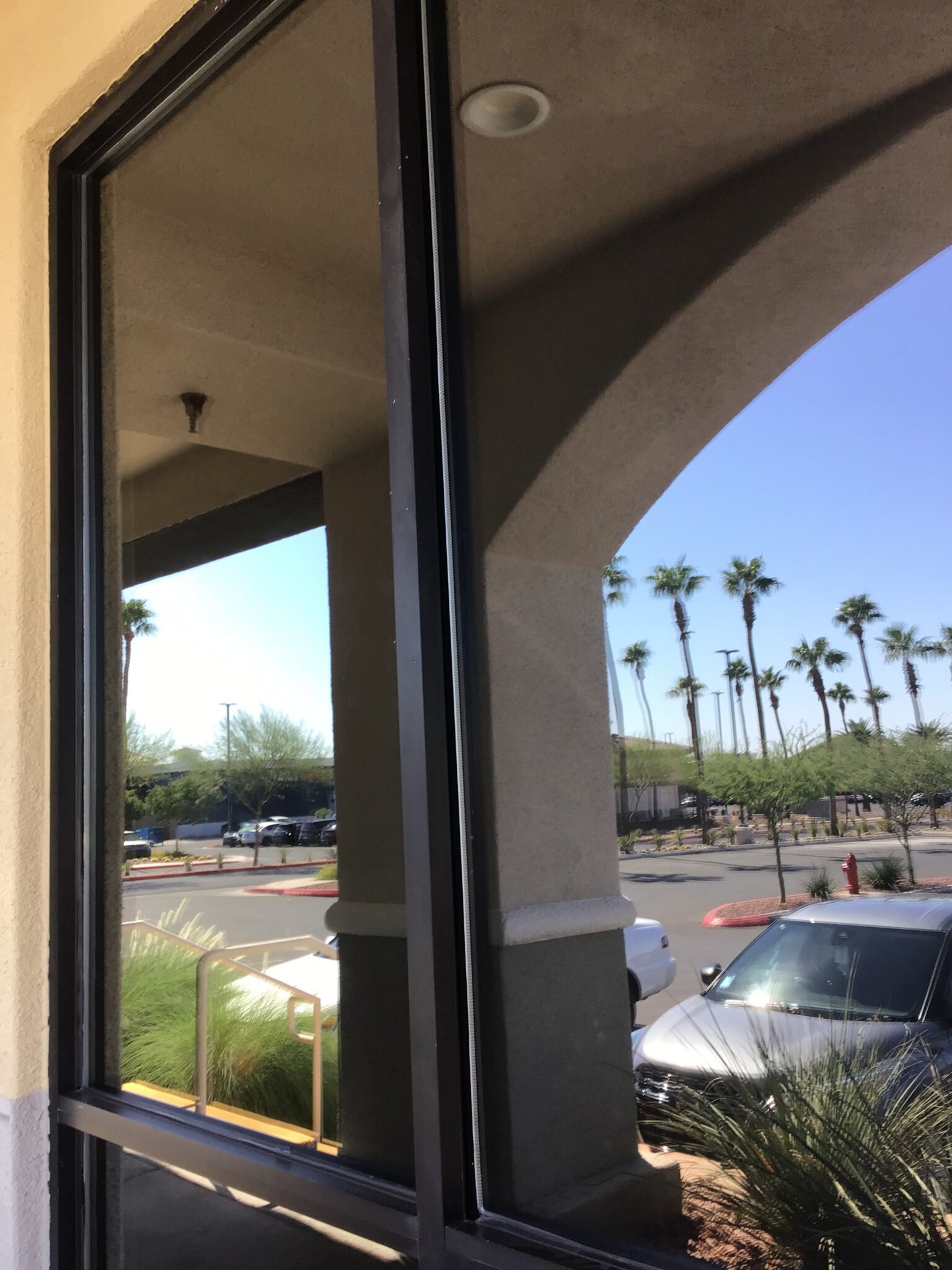 A commercial storefront window at an arched entry