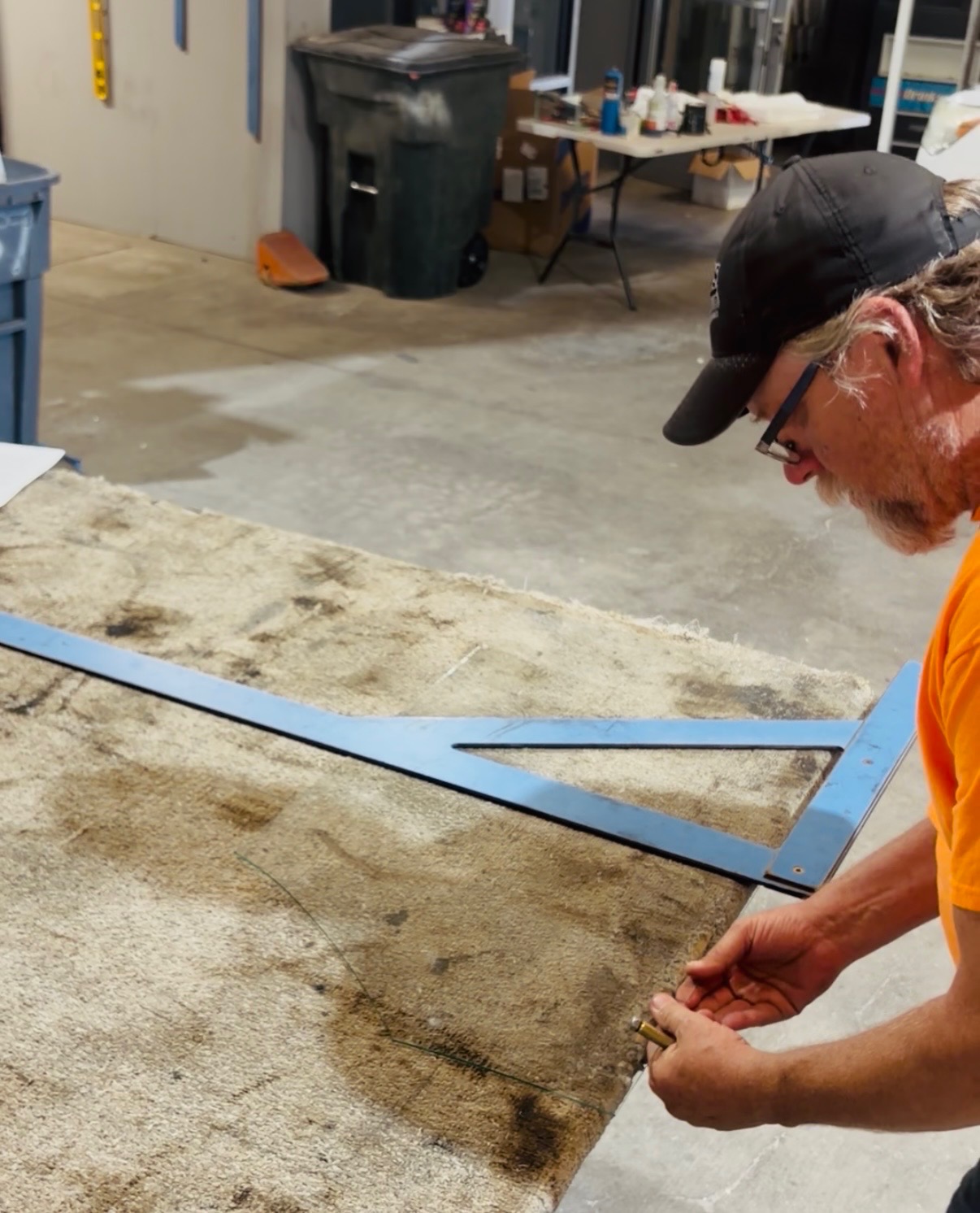 Custom Glass Cutting in Las Vegas: Any Size, Any Shape 3 A glazier scoring glass with a framing square in the shop