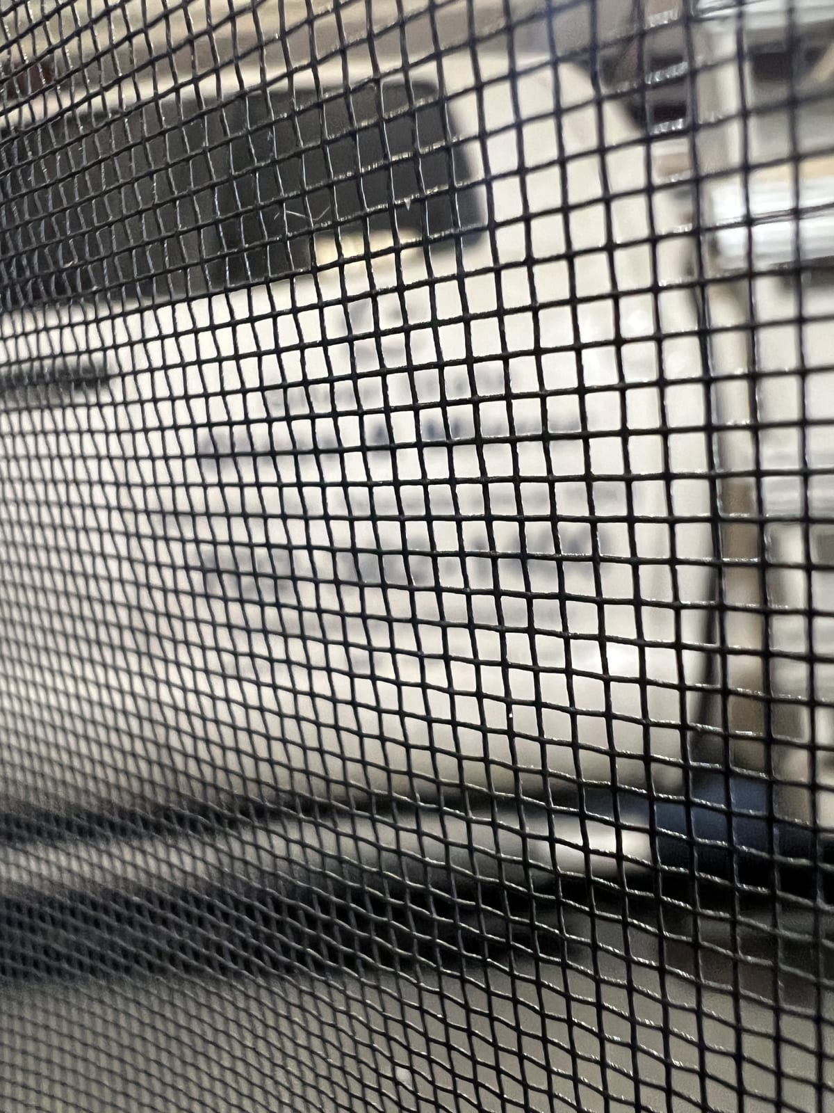Window Screen Repair & Replacement in Las Vegas 2 A close-up of window screen mesh, the woven strands and square openings visible