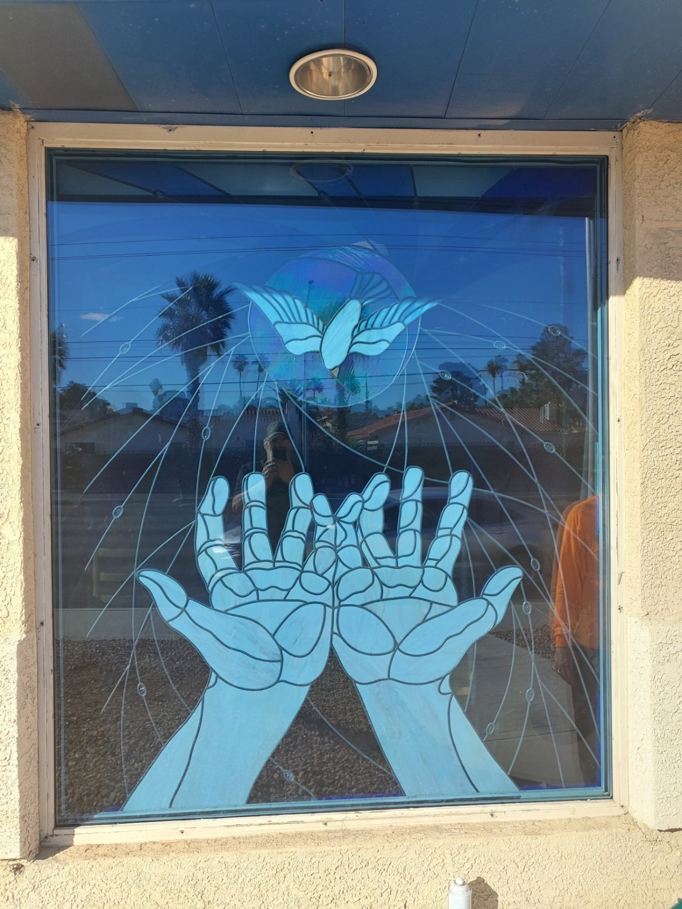 A decorative frosted-glass design on a storefront window