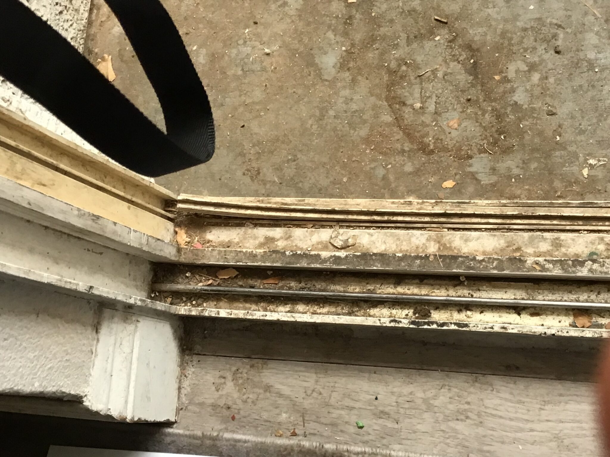 The dirty bottom track of a sliding patio door