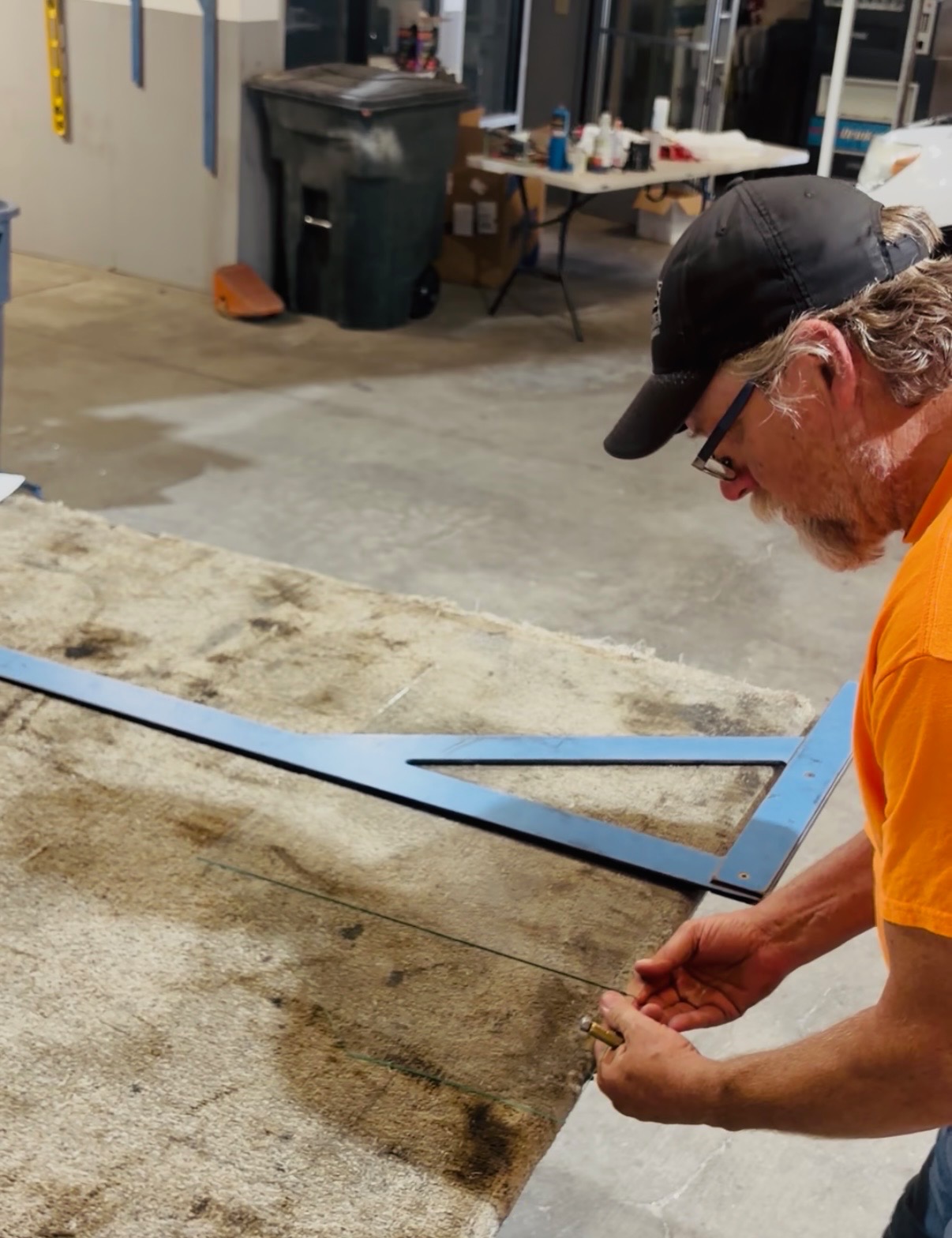 A glazier scoring and cutting glass in the Fremont Street shop