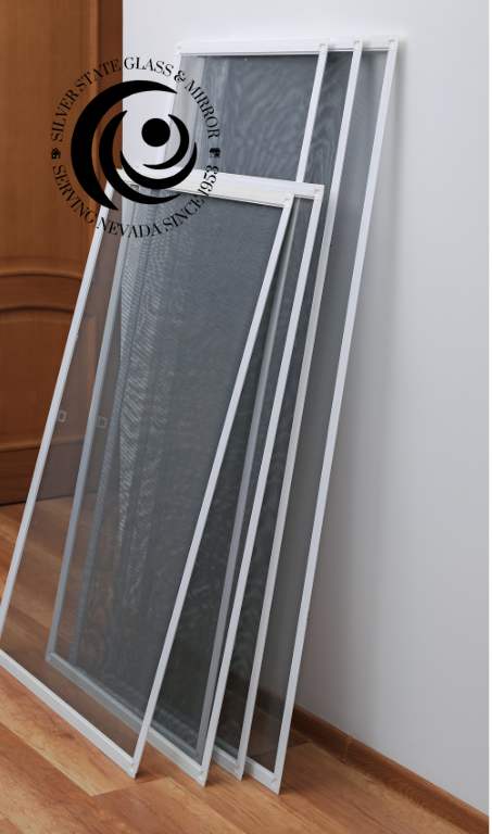 Stack of replacement window screens by Silver State Glass & Mirror, ready for installation.